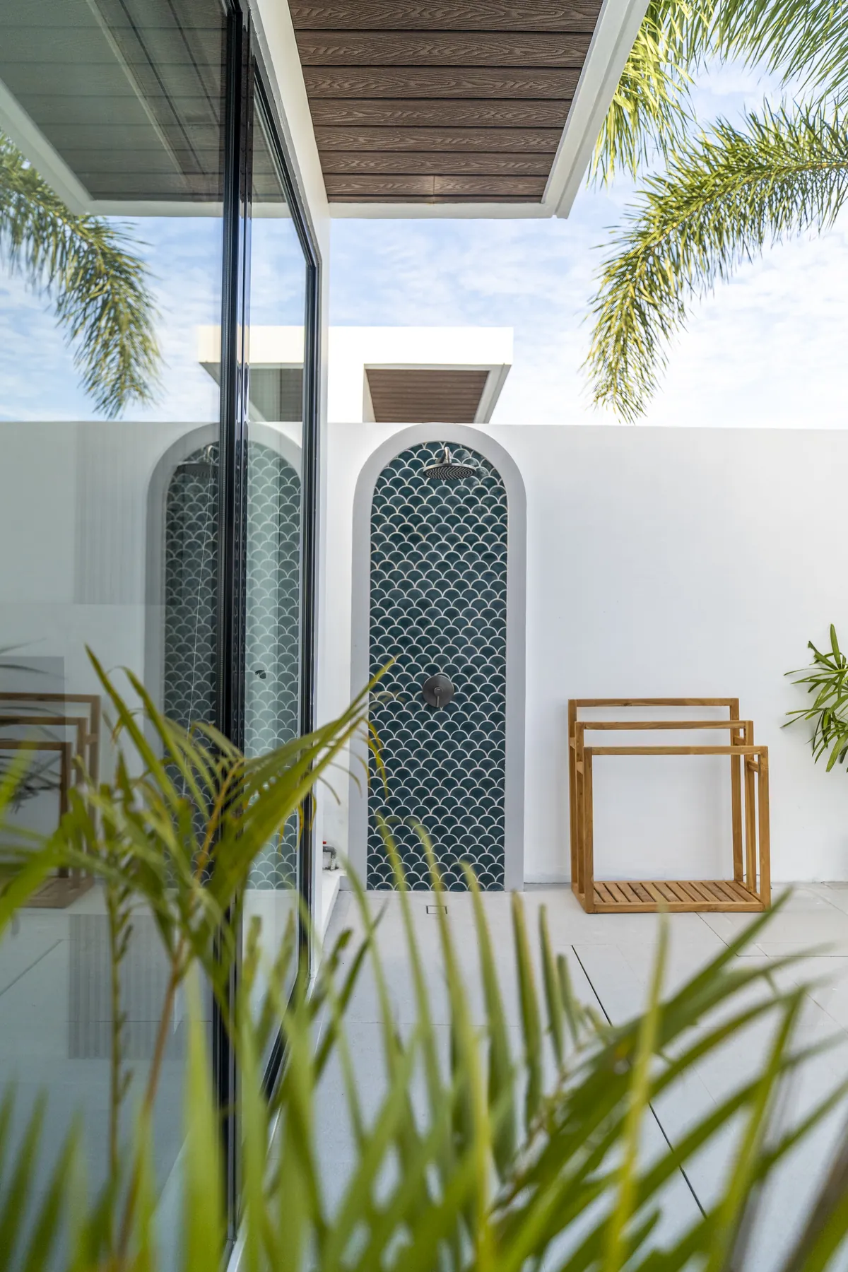 Arched villa doors framed by palms at JAGO Gili Air