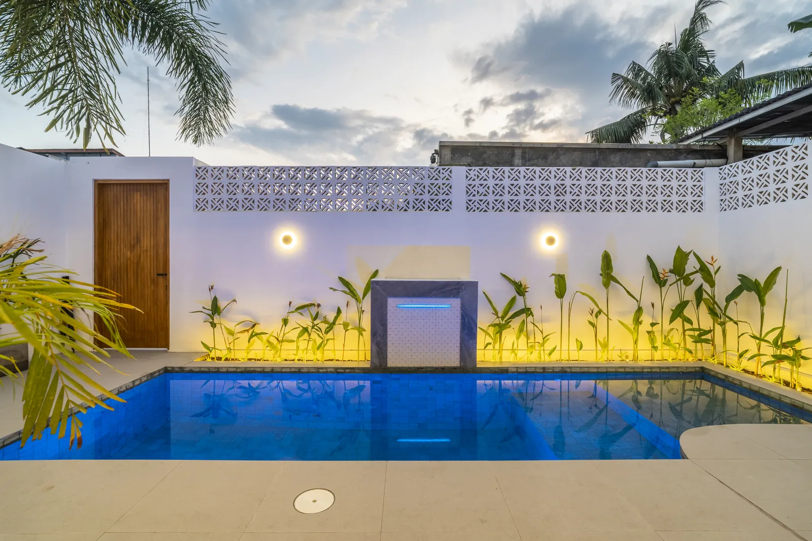 Private pool of the Two-Bedroom Villa lit up in the evening